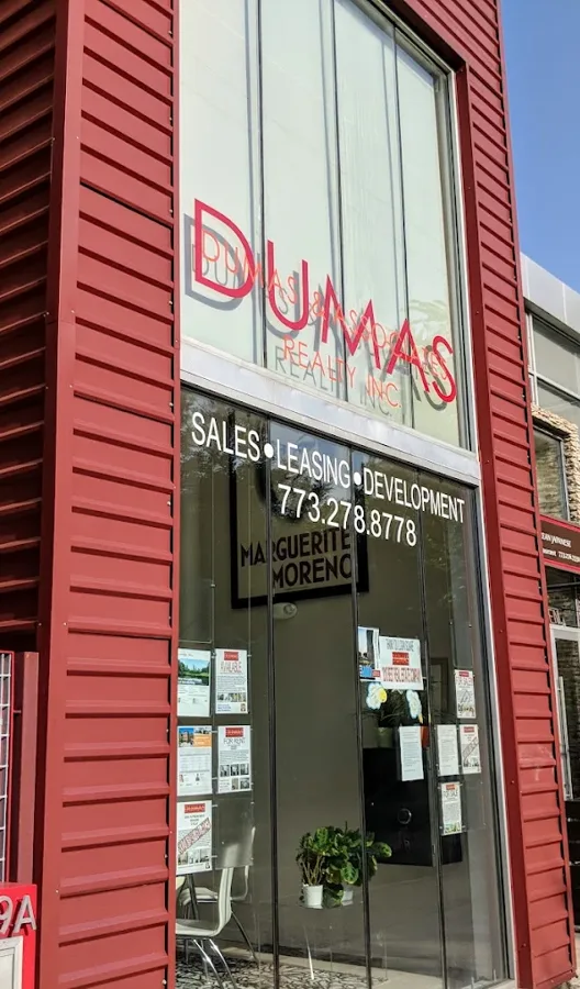 Dumas and Associates Realty storefront at 2519 N California Ave in Logan Square, Chicago: a red corrugated metal building designed and built by the family's own firm, Studio Modernista